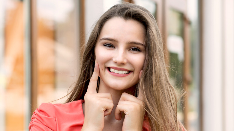 woman pressing dimples