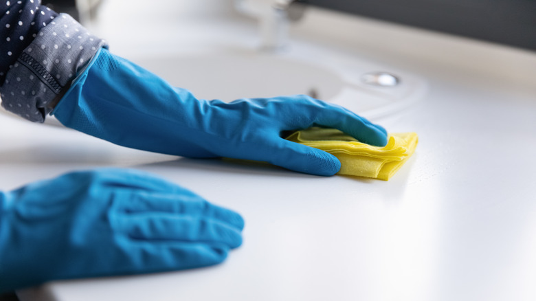 person cleaning with gloves