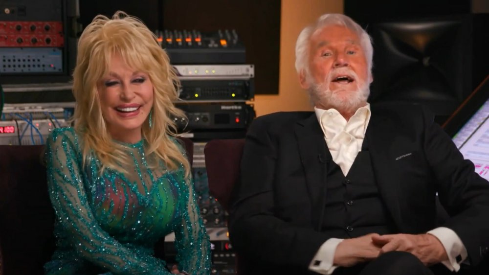 Dolly Parton and Kenny Rogers laughing in a studio