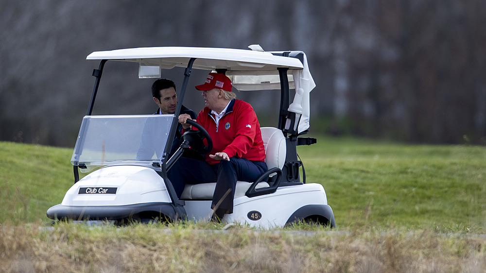 Donald Trump driving a golf cart