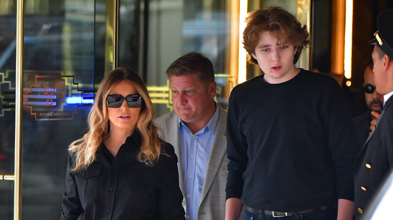 Barron and Melania Trump walking to a car