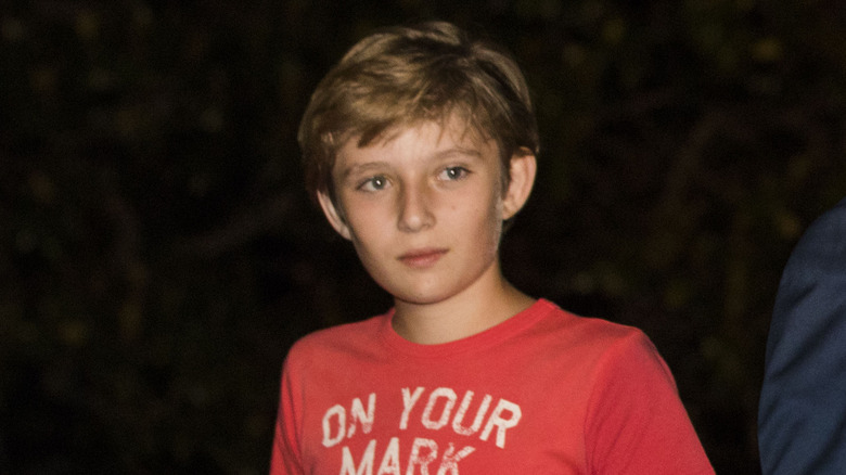 Barron Trump wearing a red T-shirt