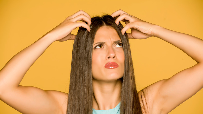 Woman using shampoo movements on hair