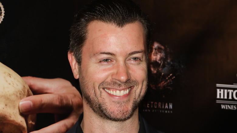 Dan Feuerriegel smiles for a photo during an event. 