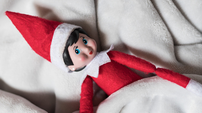 Elf on the shelf in a cozy blanket 