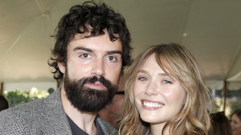 Elizabeth Olsen and Robbie Arnett smile