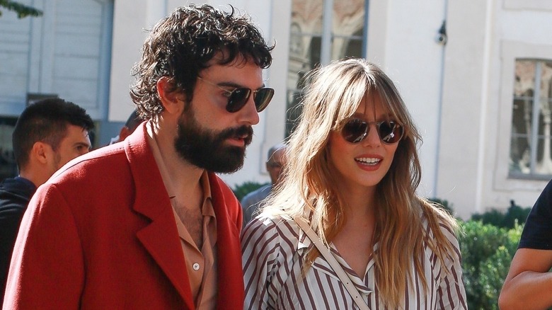 Robbie Arnett and Elizabeth Olsen outside in the sunshine