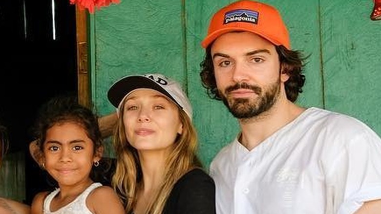 Elizabeth Olsen and Robbie Arnett with a young girl