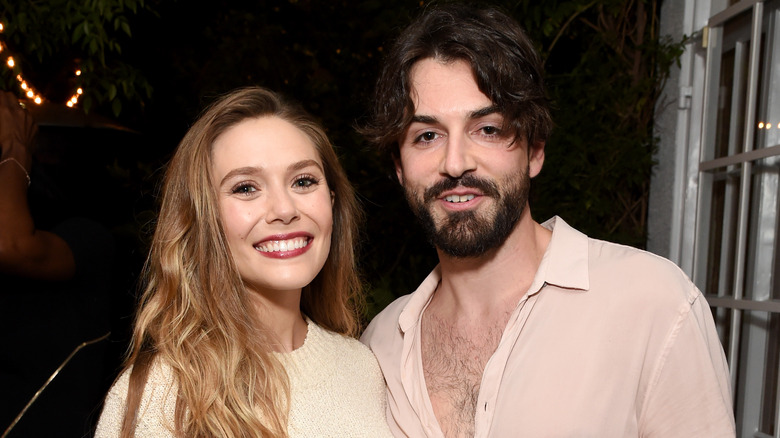 Elizabeth Olsen and Robbie Arnett in a doorway