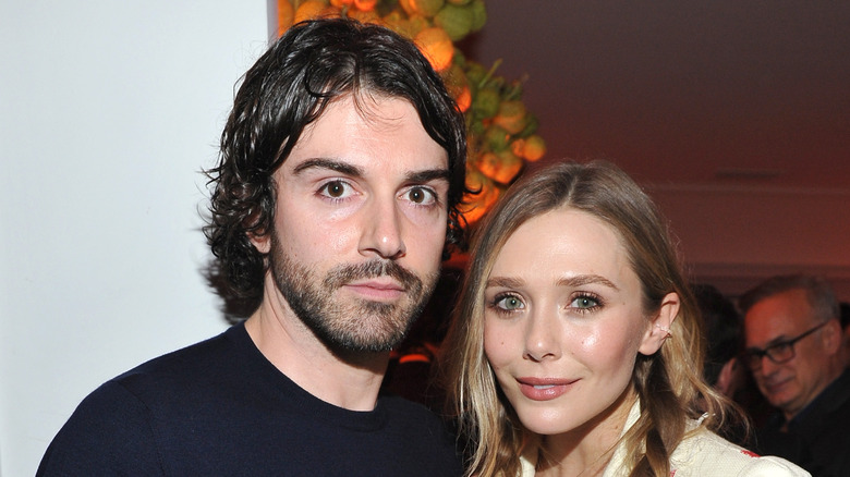 Robbie Arnett and Elizabeth Olsen at a house party