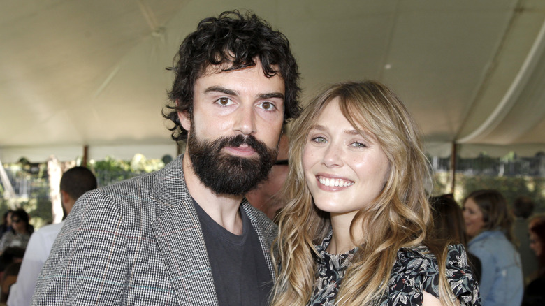 Robbie Arnett and Elizabeth Olsen at an outdoor party