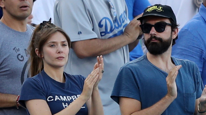 Elizabeth Olsen and Robbie Arnett at a sporting event