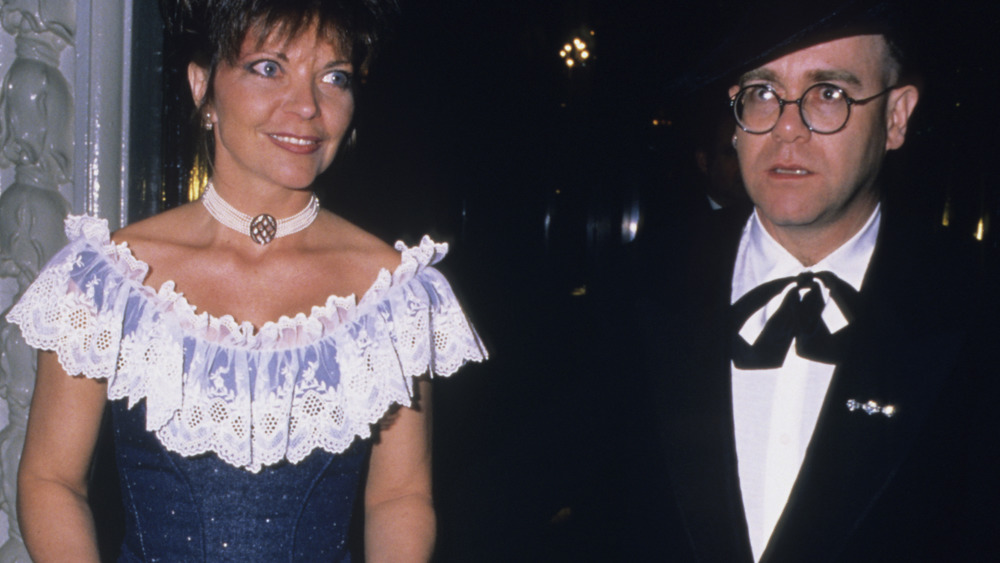 Renate Blauel and Elton John walking