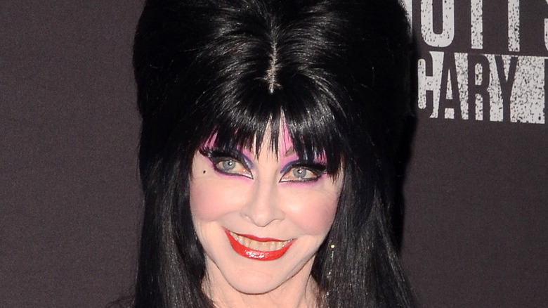 Elvira smiling for a picture at an event