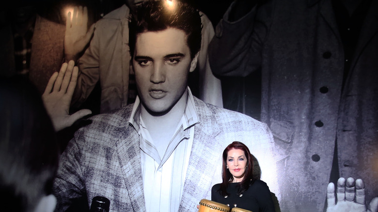 Priscilla Presley with Elvis Presley portrait 