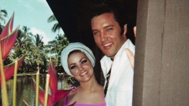 Priscilla and Elvis Presley with palm trees 