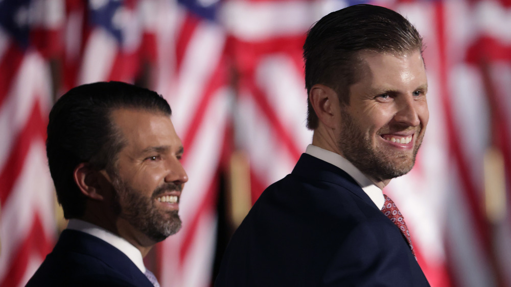 Eric and Donald Trump Jr. , looking right