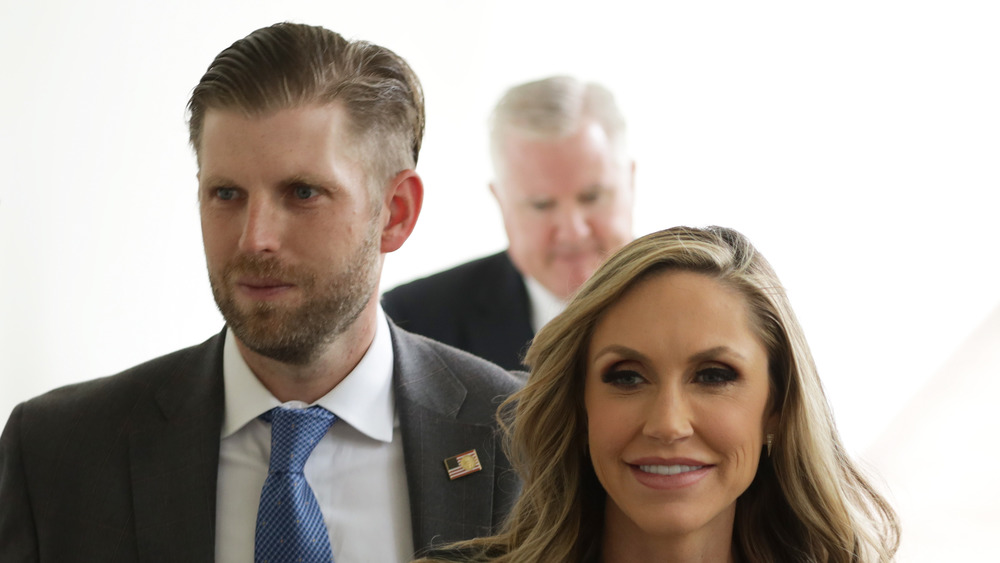 Eric and Lara Trump walking down a hallway