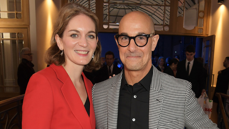 Stanley Tucci and Felicity Blunt pose at an event together