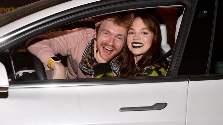 Finneas and girlfriend Claudia Sulewski pose in a car.