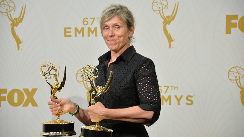 Frances McDormand holding trophies