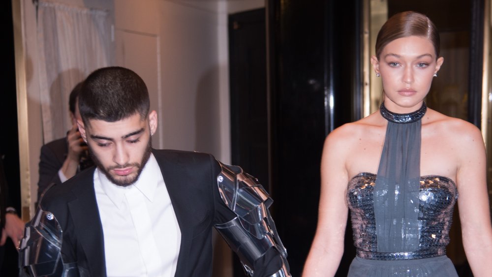 Gigi Hadid and Zayn Malik exiting a building