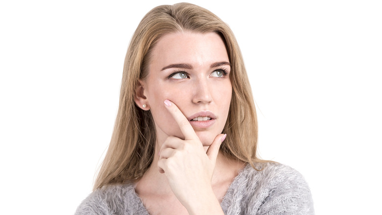 Woman with gray eyes thinking