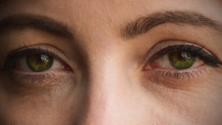 close up of woman with winged eyeliner and dark green eyes