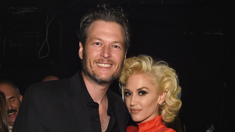 Blake Shelton and Gwen Stefani smile for the camera.