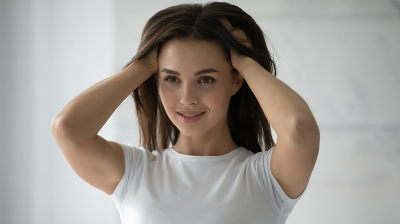 Woman burying hands in hair