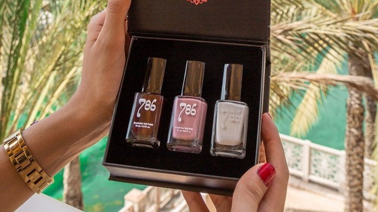 A woman holding a 786 Nail Polish Set 