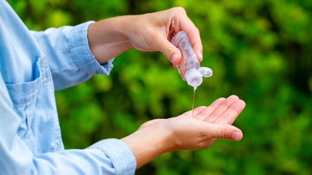 woman using hand sanitizer 