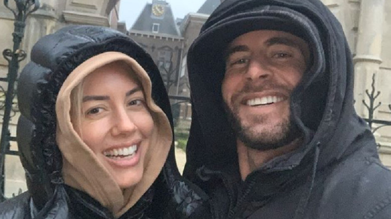 Heather Rae Young and Tarek El Moussa smiling in winter coats