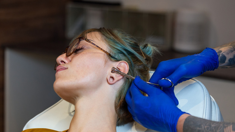 Person getting cartilage pierced