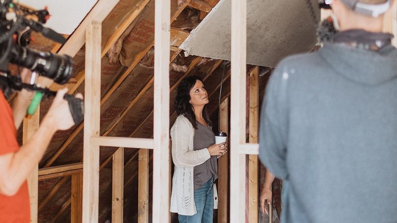 Cristi Dozier inside of a home with a camera crew around