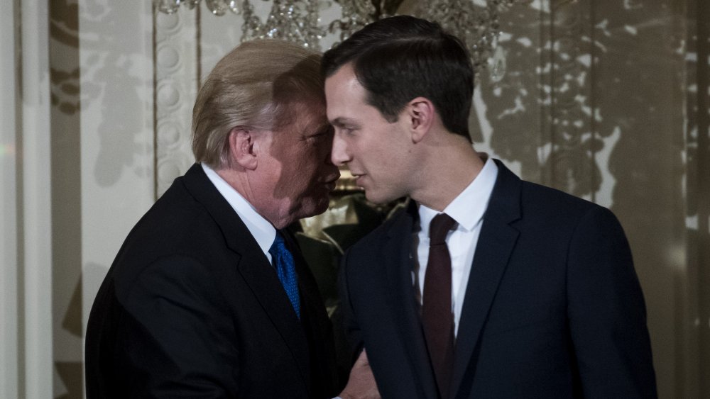 Donald Trump whispering in Jared Kushner's ear