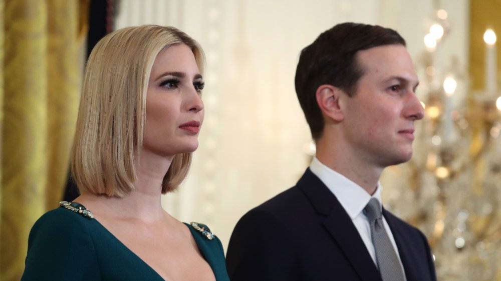 Ivanka Trump, Jared Kushner both looking off to the side with neutral expressions