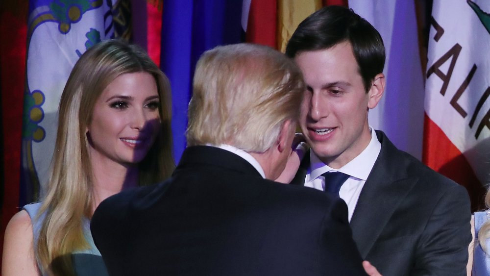 Ivanka Trump and Jared Kushner smiling at Donald Trump