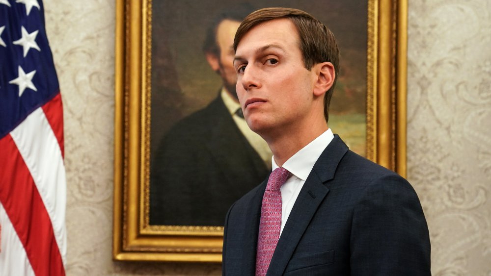 Jared Kushner posing with a raised eyebrow in front of the Lincoln portrait