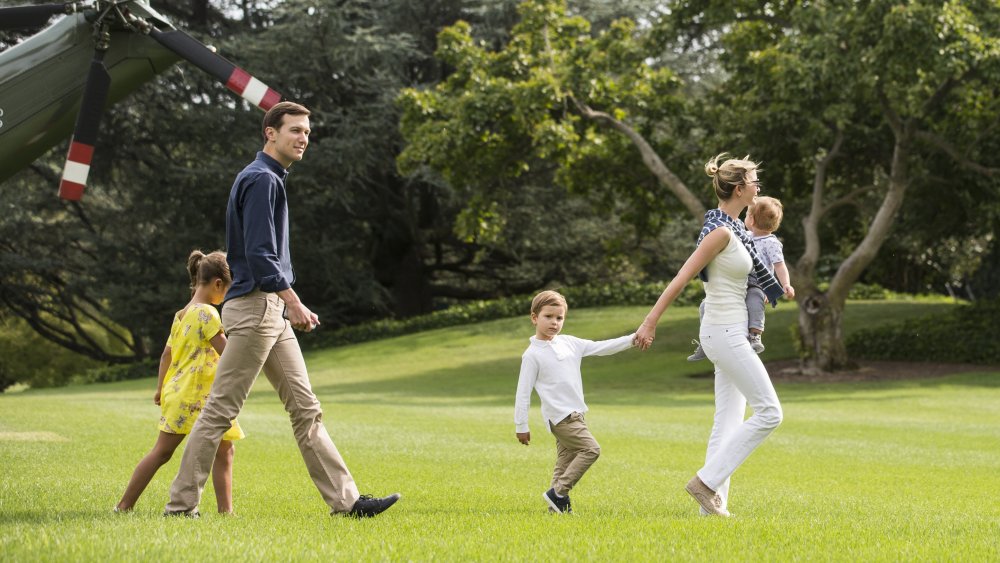 Jared Kushner and Ivanka Trump walking outside with their children