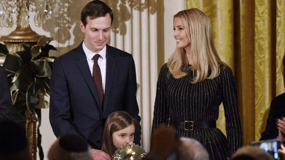 Jared Kushner smiling while looking down at his daughter, Ivanka Trump smiling at him