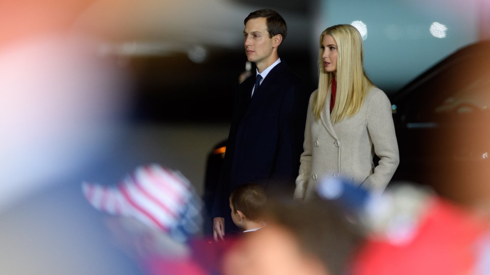 Jared Kushner and Ivanka Trump looking serious while walking outside