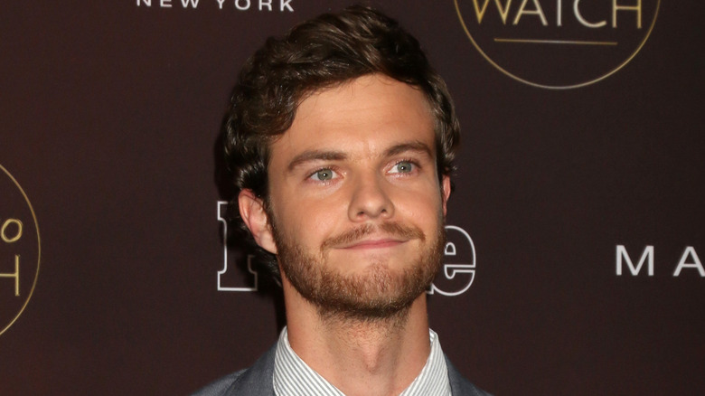 Jack Quaid wearing a gray suit