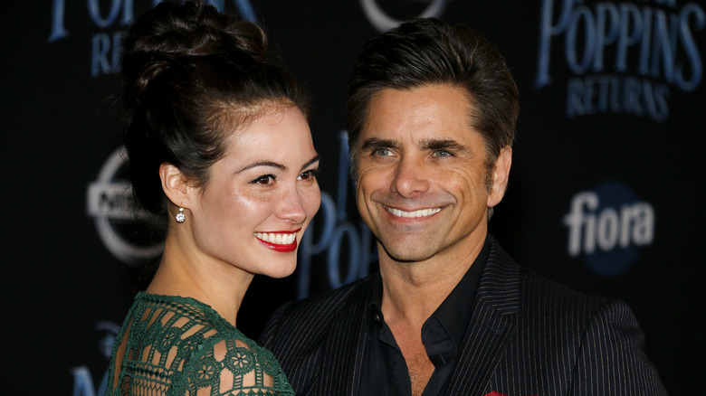 John Stamos and Caitlin McHugh posing 