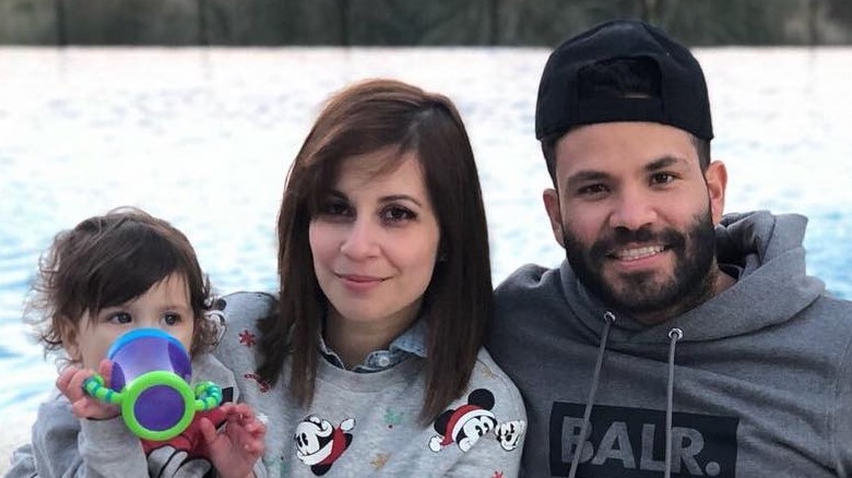 Jose and Nina Altuve posing with their daughter