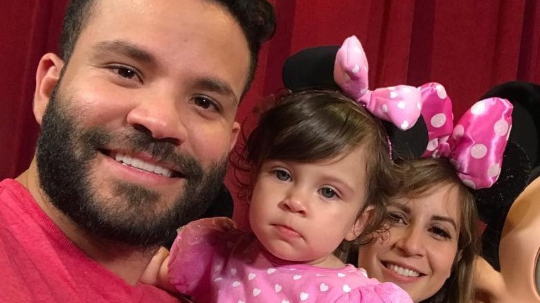 Jose and Nina Altuve posing with their daughter