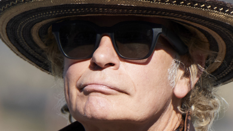 julien temple wearing a hat and sunglasses