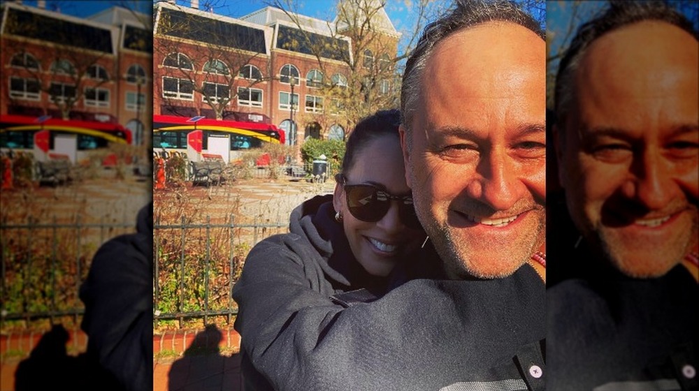 Kamala Harris and Doug Emhoff in front of buildings