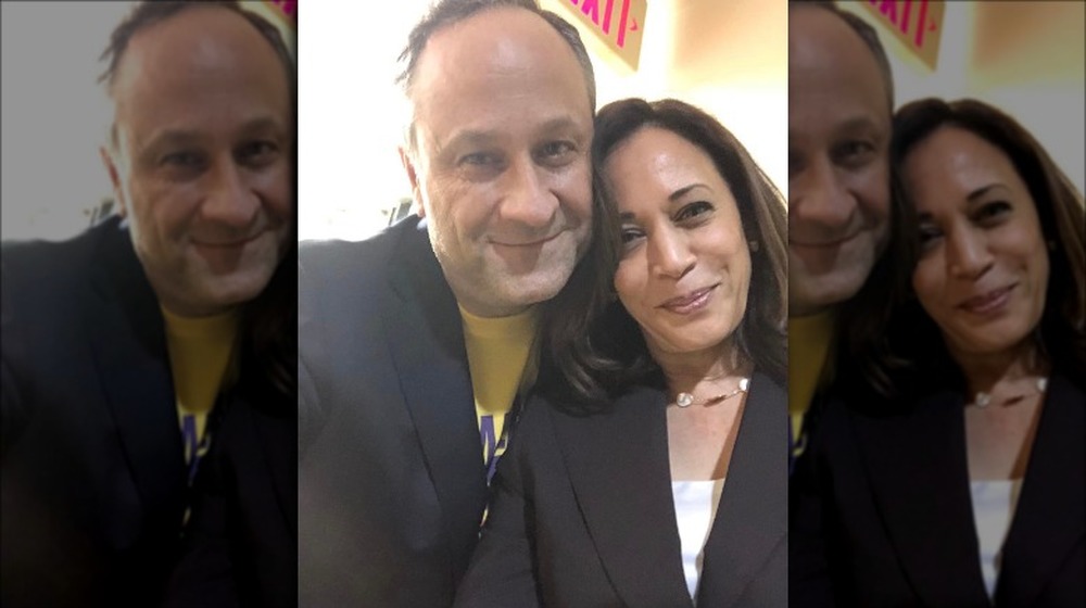 Kamala Harris and Doug Emhoff in front of an exit sign