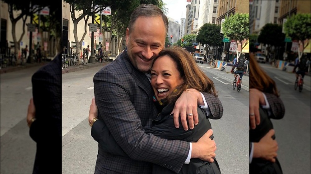 Kamala Harris and Doug Emhoff hugging in the street